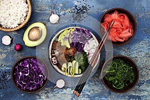 Hawaiian tuna poke bowl with seaweed, avocado, red cabbage slaw, radishes and black sesame seeds.