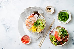 Hawaiian tuna and shrimp poke bowls with seaweed, avocado, mango, pickled ginger, sesame seeds.