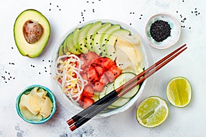 Hawaiian watermelon poke bowl with avocado, cucumber, mung bean sprouts and pickled ginger. Top view, overhead