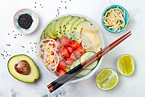 Hawaiian watermelon poke bowl with avocado, cucumber, mung bean sprouts and pickled ginger. Top view, overhead