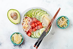 Hawaiian watermelon poke bowl with avocado, cucumber, mung bean sprouts and pickled ginger. Top view, overhead