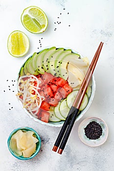 Hawaiian watermelon poke bowl with avocado, cucumber, mung bean sprouts and pickled ginger. Top view, overhead