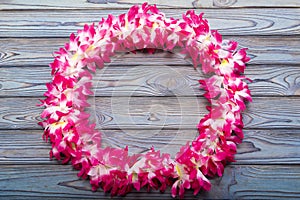 Hawaiian wreath on a wooden background.