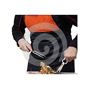 Hawkish rotisserie attendant cuts and serves grilled chicken-