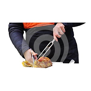 Hawkish rotisserie attendant cuts and serves grilled chicken-