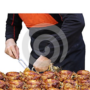 Hawkish rotisserie attendant cuts and serves grilled chicken-