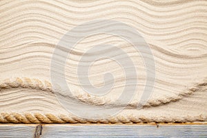 Hawser and old wooden plank on beach background