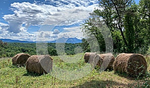 Hay bales on a beautiful summertime day on the Via Francigena, Lunigiana, Tuscany, Italy. photo