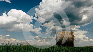 Hay bales in a field on a cloudy summers day.