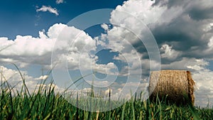 Hay bales in a field on a cloudy summers day.