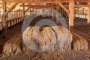 Hay bales stacked in old wooden barn on historic cattle ranch