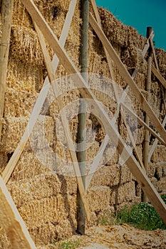 Hay bales stacks outdoors as wall