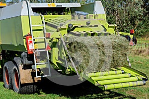 Hay baling with balers. Preparation of silage for the winter for animals.