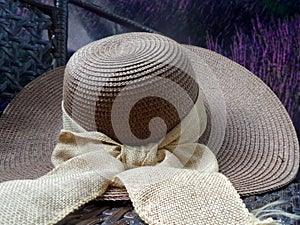 Hay hat and beautiful ribbin in flower garden photo