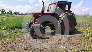 Hay mowing with tractor mounted rotary mower on a hayfield