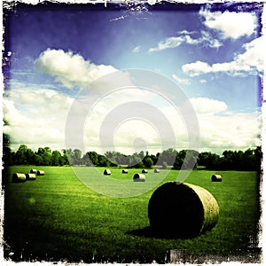 Hay stacks in green field