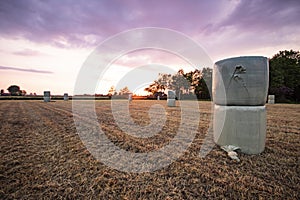 Haybales in front of a purple sky in the evening