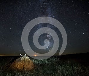 Haystack in the meadow and the Milky Way.