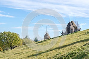 Haystacks on a grass hill. Farming theme