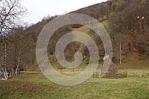 Haystacks on a meadow near Beli Vit River photo