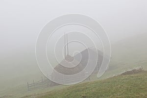 Haystacks in misty morning