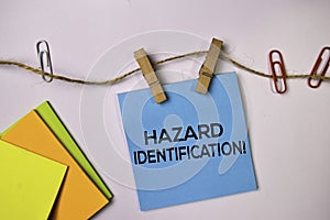 Hazard Identification! on sticky notes isolated on white background photo