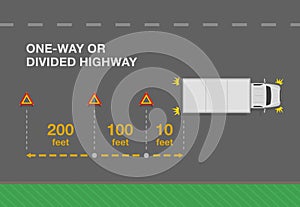 Hazard or warning triangle placement distance. Red breakdown triangle stands behind the broken truck on road side.