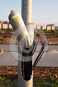 hazardous area, metal pole, electrical wires are torn off, a danger sign on a pillar,