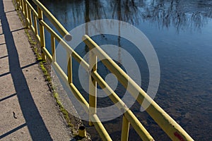 Hazardous Bridge: Broken Fence and Damaged Structure Over the River