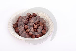 Hazel nuts in an areca leaf bowl