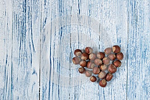 Hazel nuts heart Blue and whie Old grunge wooden background