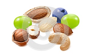 Hazelnut, blanched almond, cashew nuts, green and blue grapes isolated on white background