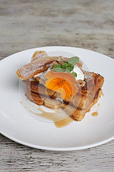Hazelnut Caramalized Banana Brioche Fench Toast served in dish isolated on wooden background top view of breakfast photo