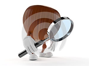 Hazelnut character looking through magnifying glass