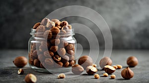 Hazelnut in a glass jar on a concrete background. Clean eating, vegan, balanced dieting food concept.