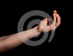 hazelnut in hand on black