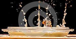 Hazelnut in milk splash. Drops on a wooden table