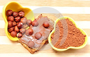 Hazelnut and slices of bread with chocolate cream