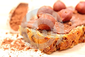 Hazelnut and slices of bread with chocolate cream