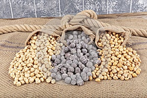 Hazelnut varieties on linen background and linen lathes. Roasted shelled hazelnuts, shelled hazelnuts and shellless roasted