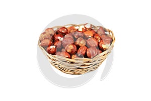 Hazelnuts in basket isolated on white