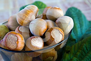 Hazelnuts in a brown glass bowl