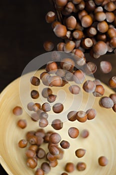 Hazelnuts in Motion Tumbling into Bamboo Bowl