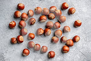 Hazelnuts peeled and in shell on gray background. Background and textures