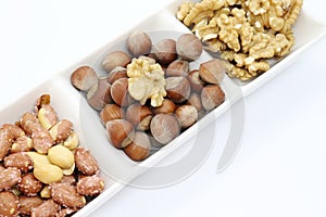 hazelnuts and walnut kernels isolated on white background