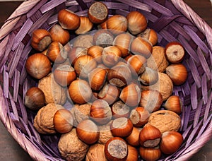 Hazelnuts and walnuts in the beautiful lilac basket