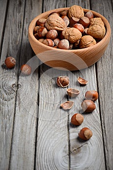 Hazelnuts and walnuts in a wooden bowl