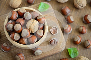 Hazelnuts and walnuts in a wooden bowl