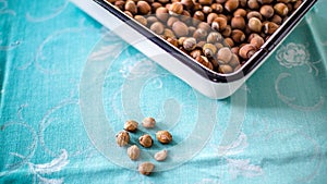 Hazelnuts in the white containers on the blue table