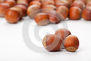 Hazelnuts on white surface